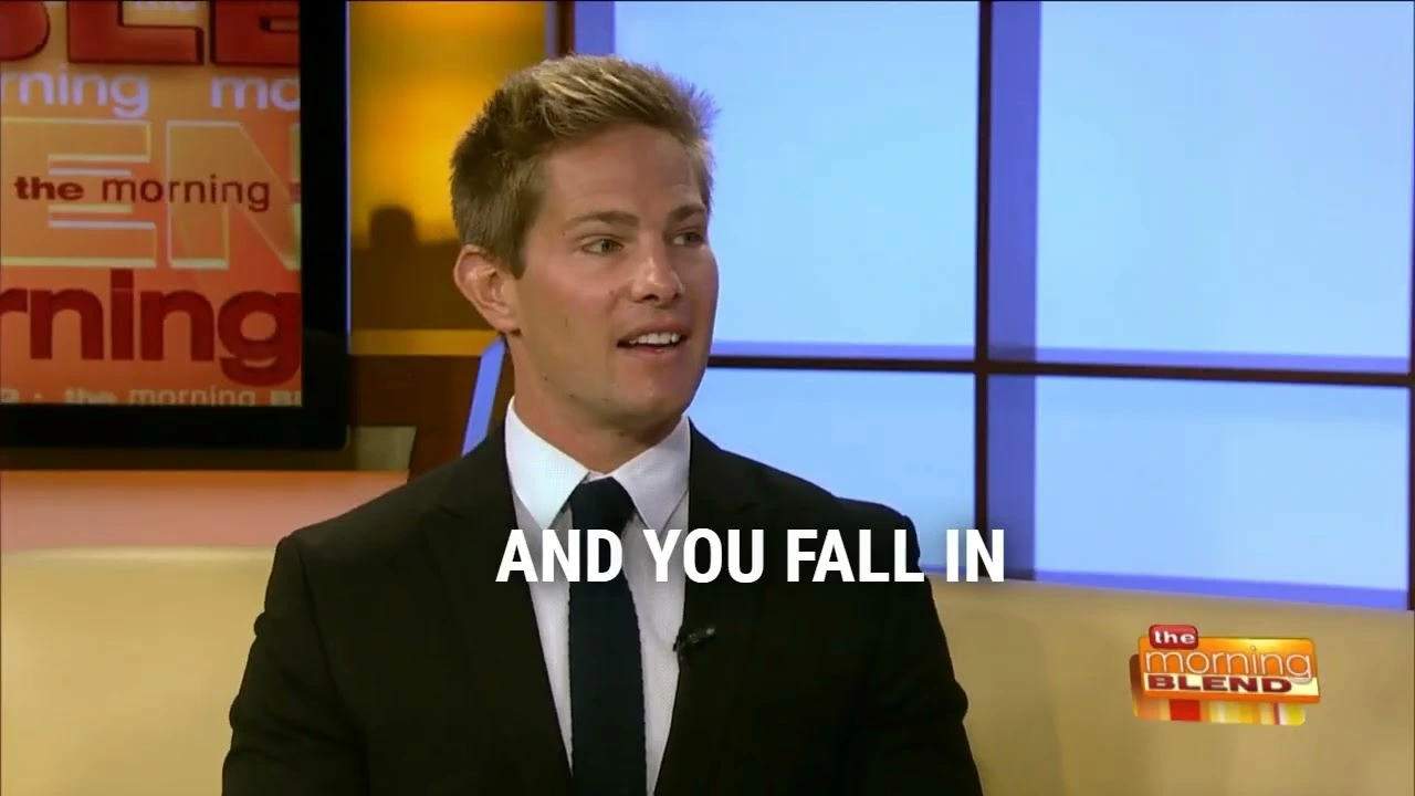 Man in a black suit speaking during a TV interview on The Morning Blend show.