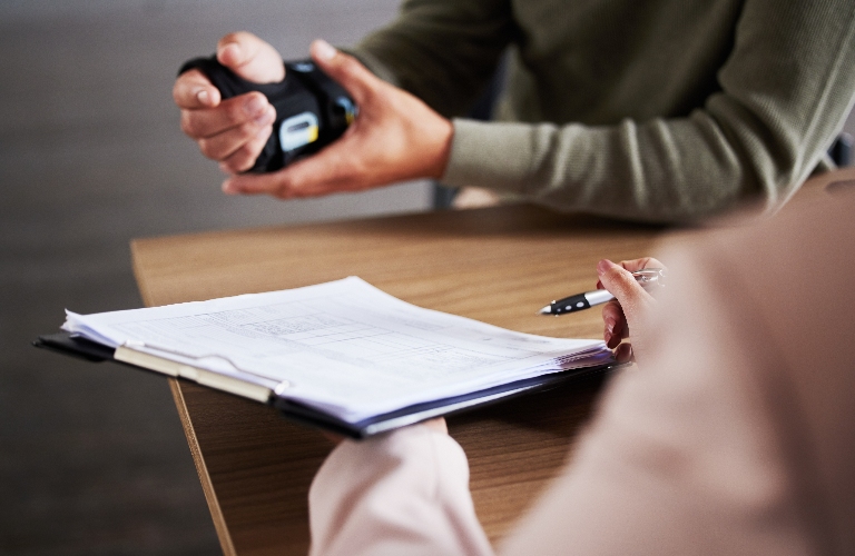 man with hand injury is consulting with lawyer