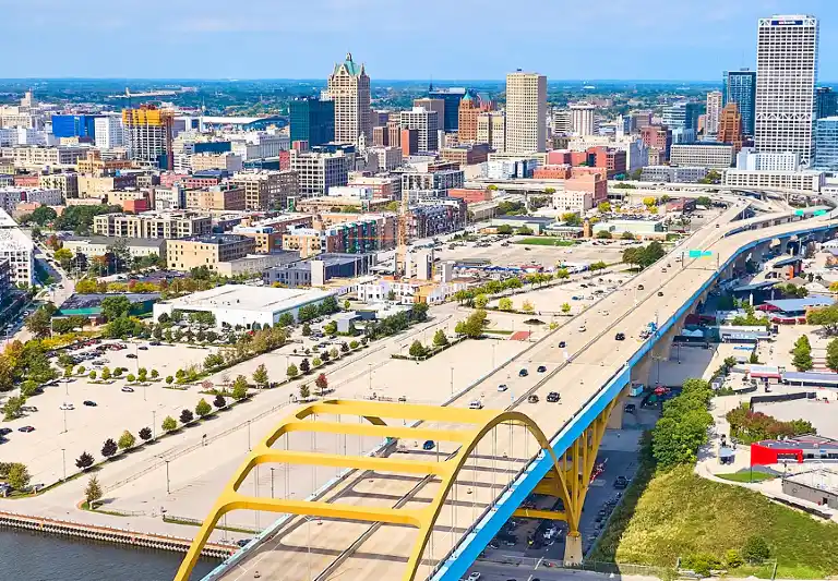 Aerial view of Milwaukee, Wisconsin skyline, featuring the Hoan Bridge and lakefront.