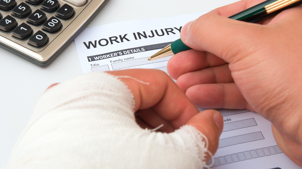 man with hand's injury id filling out work injury claim