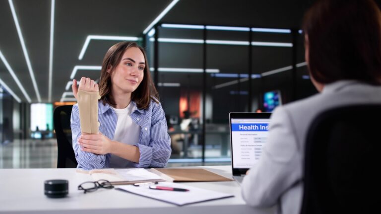 Woman with injured hand files worker compensation claim with insurance lawyer